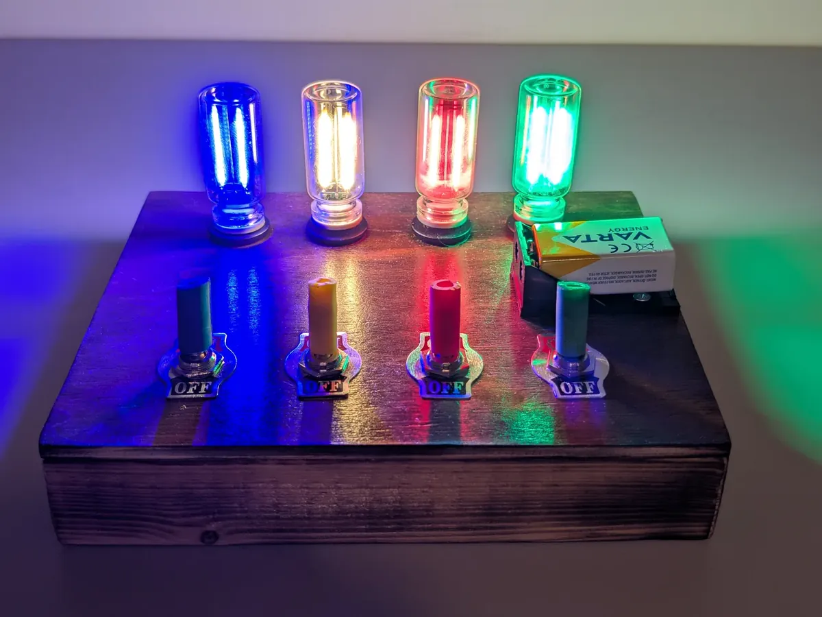 The Turing Box, Edison Edition: wooden box with four coloured filament bulbs lit and four toggle switches